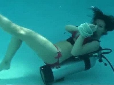 Scuba girl tied to pool ladder