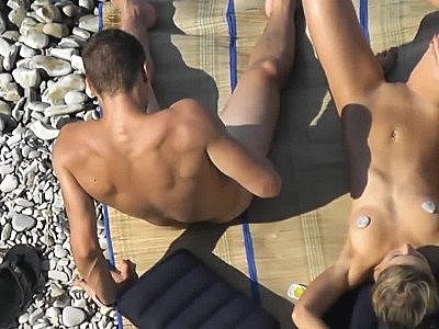 Guy Jerks dick before her girlfriend at a public beach