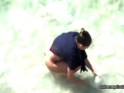 Stepmother wades naked in the surf